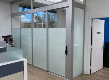 L-shape glass office with transom on top, and smart lock in FL